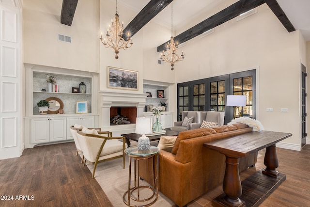 living room with dark hardwood / wood-style floors, beam ceiling, a high ceiling, and built in shelves