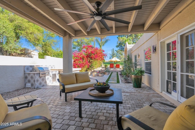 view of patio / terrace with ceiling fan, area for grilling, an outdoor living space, and grilling area