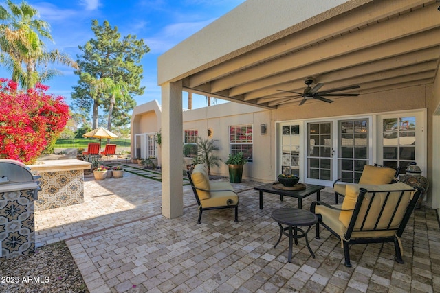 view of patio / terrace with an outdoor kitchen and ceiling fan