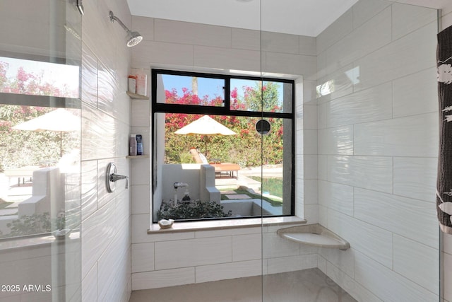 bathroom featuring tile walls and walk in shower