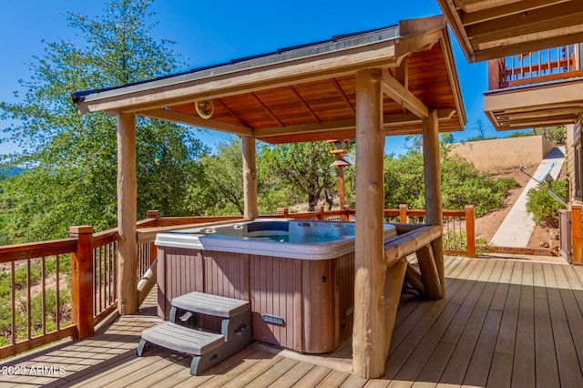 wooden terrace with a hot tub