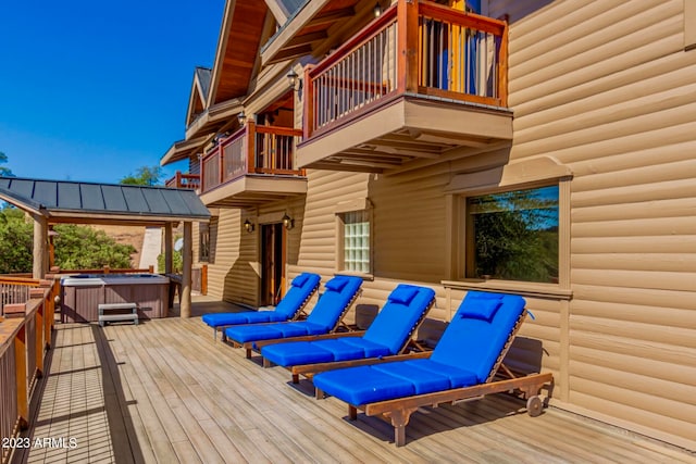 wooden deck with a hot tub