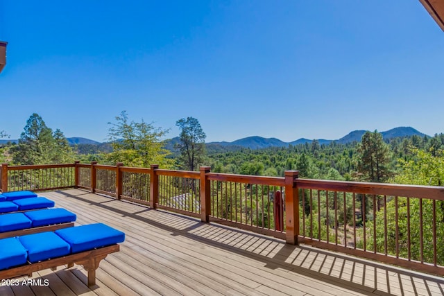 wooden deck with a mountain view