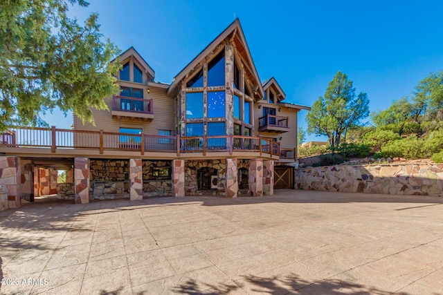 back of property featuring a wooden deck