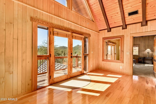 unfurnished sunroom featuring french doors, vaulted ceiling with beams, and wooden ceiling