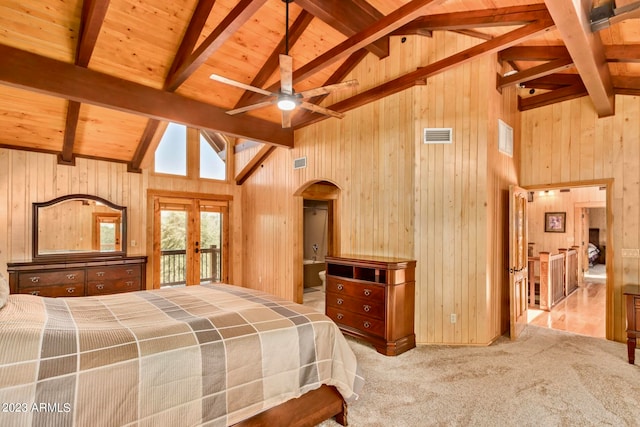 bedroom featuring wooden walls and beam ceiling