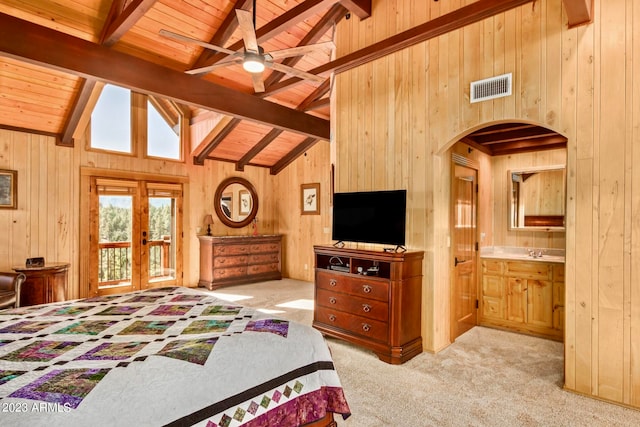 carpeted bedroom featuring beam ceiling, french doors, wood walls, and wood ceiling