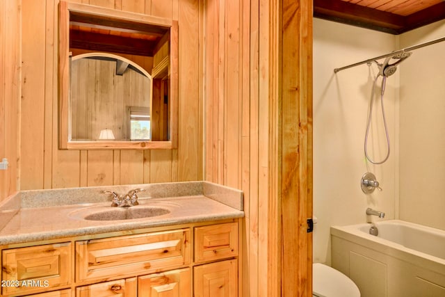 full bathroom with toilet, vanity, wooden walls, bathtub / shower combination, and wood ceiling