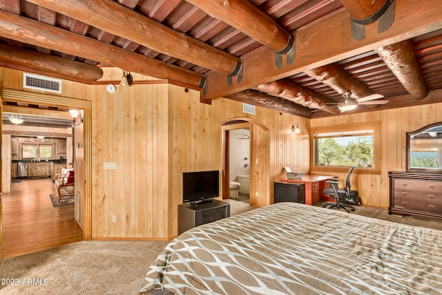 bedroom with wooden ceiling, beam ceiling, and wooden walls