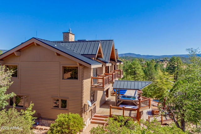 back of house featuring a deck