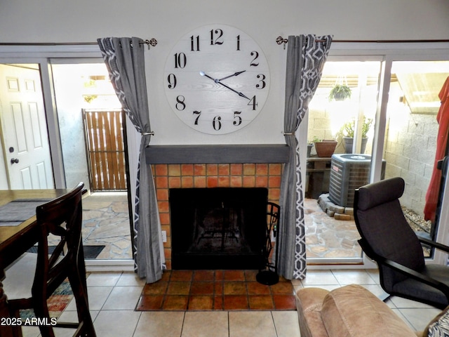 tiled living room featuring a tiled fireplace and a wealth of natural light