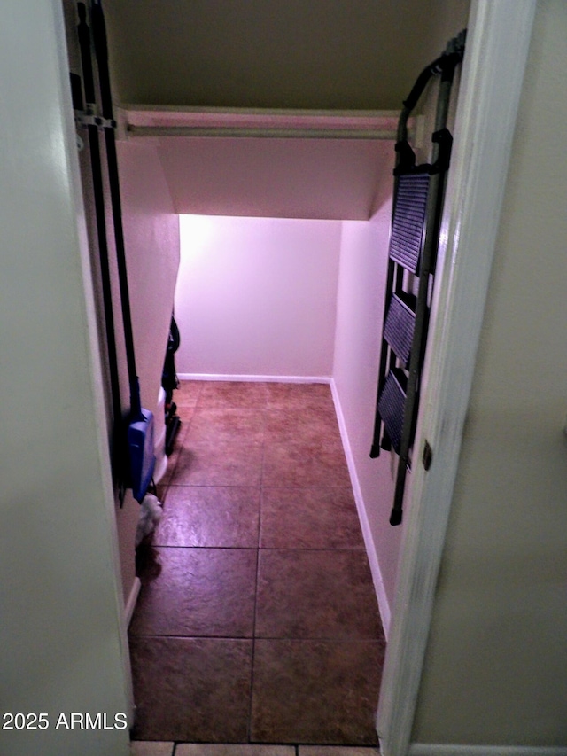 hall featuring baseboards
