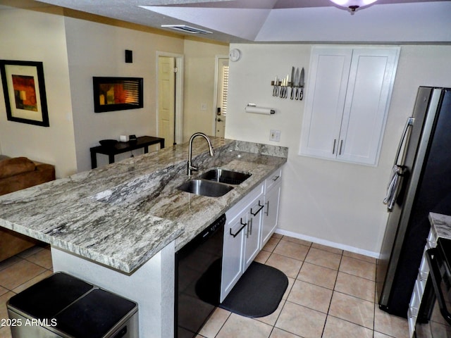 kitchen featuring a peninsula, light tile patterned floors, white cabinets, a sink, and dishwasher