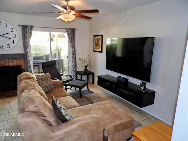 tiled living room with a ceiling fan and a fireplace