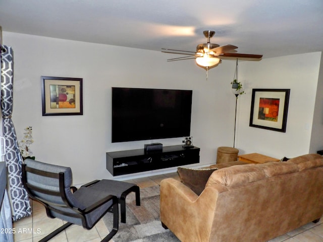 living area with a ceiling fan and light tile patterned floors