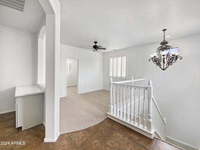 4319 E Vaughn Ave, Gilbert, AZ 85234 - hall featuring an upstairs landing, arched walkways, dark colored carpet, dark tile patterned floors, and a chandelier