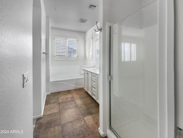 4319 E Vaughn Ave, Gilbert, AZ 85234 - bathroom featuring a stall shower, vanity, a bath, and stone finish flooring