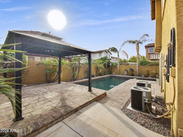 view of pool with a patio and central AC