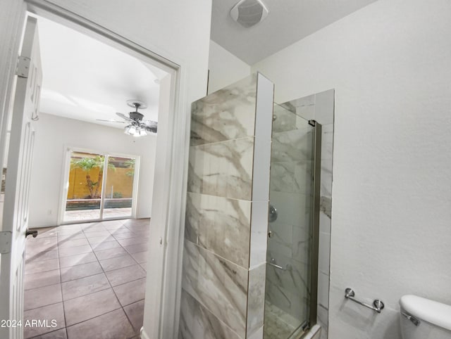 bathroom with toilet, ceiling fan, tile patterned flooring, and walk in shower