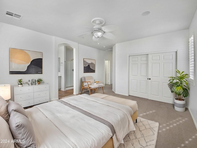 bedroom featuring ceiling fan, a closet, and carpet