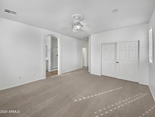 unfurnished bedroom featuring carpet flooring, ceiling fan, and a closet