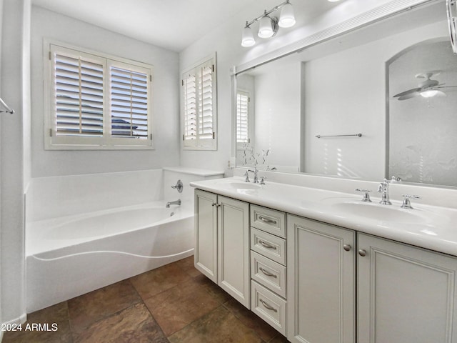 bathroom featuring ceiling fan, a bathtub, and vanity