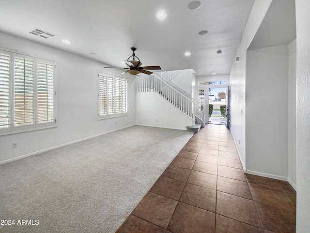 carpeted entrance foyer with ceiling fan