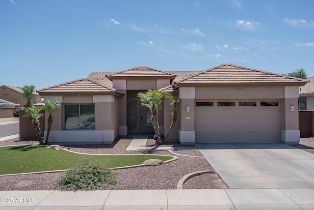 12503 W Vista Paseo Dr, Litchfield Park, AZ 85340 - prairie-style home with a tiled roof, driveway, a front yard, an attached garage, and stucco siding
