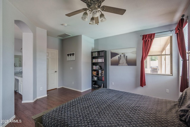 12503 W Vista Paseo Dr, Litchfield Park, AZ 85340 - bedroom with ceiling fan, arched walkways, baseboards, wood finished floors, and visible vents
