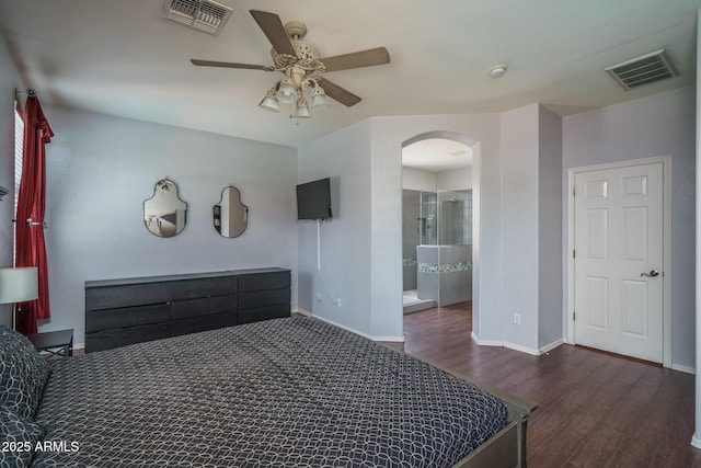 12503 W Vista Paseo Dr, Litchfield Park, AZ 85340 - bedroom with arched walkways, baseboards, visible vents, and wood finished floors