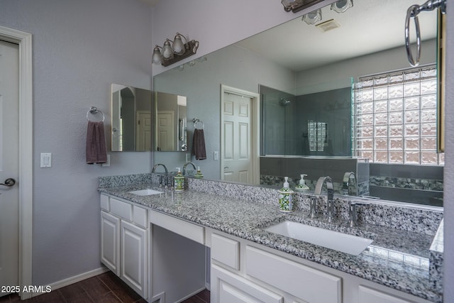 12503 W Vista Paseo Dr, Litchfield Park, AZ 85340 - bathroom featuring double vanity, baseboards, a sink, and wood finished floors