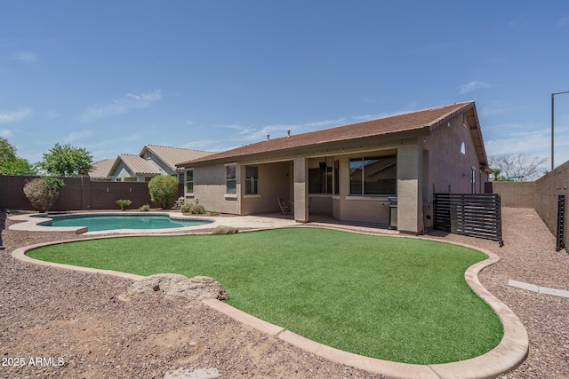 12503 W Vista Paseo Dr, Litchfield Park, AZ 85340 - rear view of property featuring stucco siding, a fenced backyard, a fenced in pool, a patio, and a yard