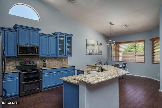 12503 W Vista Paseo Dr, Litchfield Park, AZ 85340 - kitchen featuring a sink, blue cabinetry, stainless steel appliances, dark wood-type flooring, and backsplash
