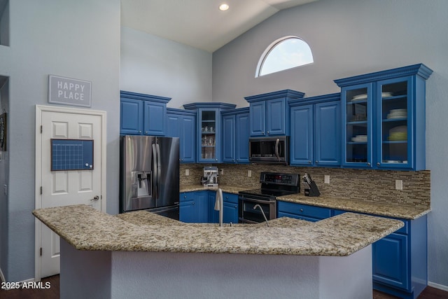 12503 W Vista Paseo Dr, Litchfield Park, AZ 85340 - kitchen featuring appliances with stainless steel finishes, a kitchen island with sink, high vaulted ceiling, tasteful backsplash, and blue cabinets