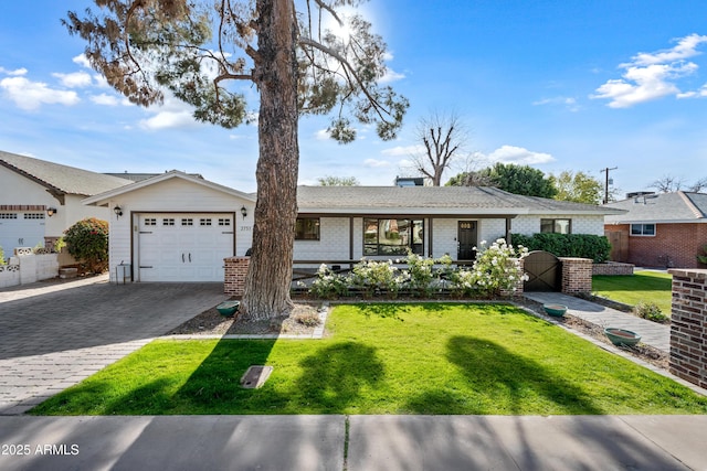 ranch-style house featuring a garage and a front yard