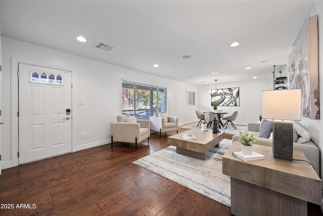 living room with hardwood / wood-style floors and an inviting chandelier