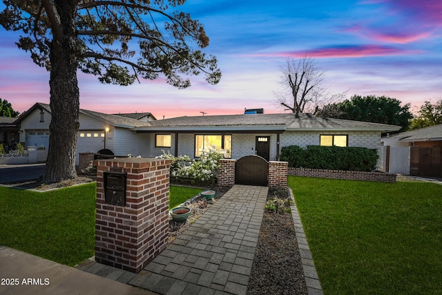 ranch-style house with a lawn