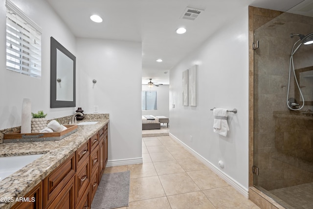 bathroom featuring tile patterned flooring, ceiling fan, walk in shower, and vanity