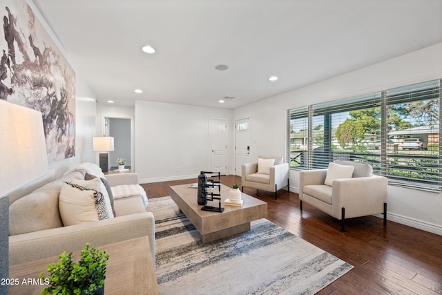 living room featuring dark hardwood / wood-style floors and a wealth of natural light