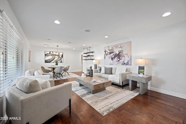 living room with a wealth of natural light and dark hardwood / wood-style floors