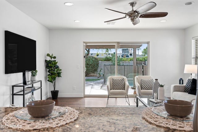 living room featuring ceiling fan and hardwood / wood-style flooring