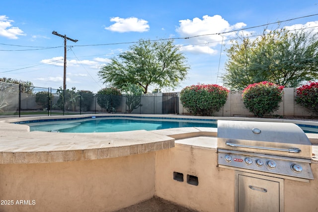 view of pool featuring area for grilling