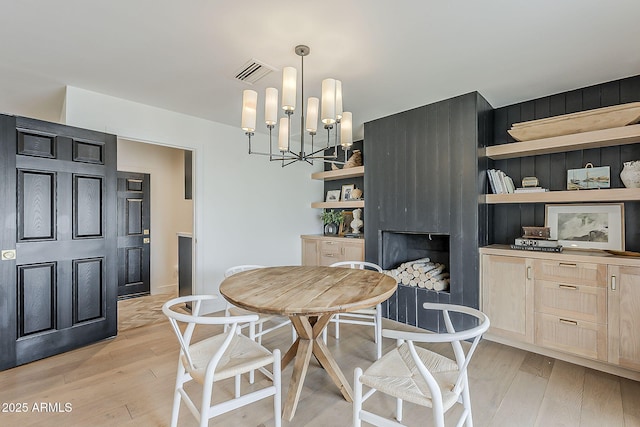 8320 E Monte Vista Rd, Scottsdale, AZ 85257 - dining space featuring light wood-style floors and a chandelier