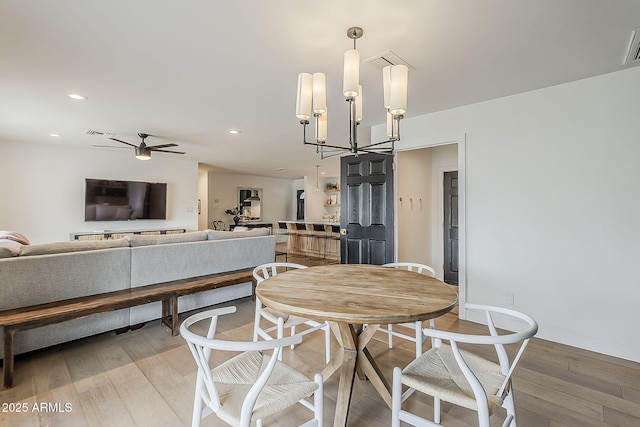8320 E Monte Vista Rd, Scottsdale, AZ 85257 - dining area featuring light wood-style floors, a chandelier, ceiling fan, recessed lighting, and baseboards