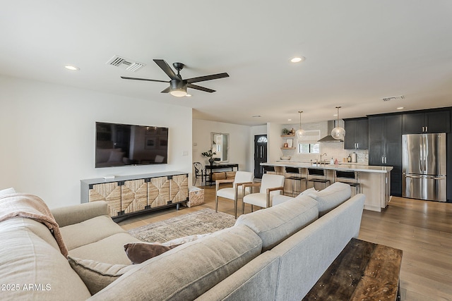 8320 E Monte Vista Rd, Scottsdale, AZ 85257 - living area featuring ceiling fan, recessed lighting, and light wood finished floors