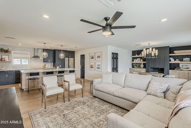 8320 E Monte Vista Rd, Scottsdale, AZ 85257 - living room featuring ceiling fan, recessed lighting, light wood-type flooring, a chandelier, and baseboards