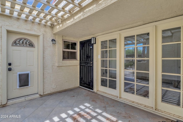 entrance to property with a patio area and a pergola