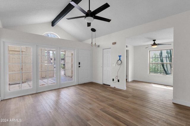 interior space with wood-type flooring, vaulted ceiling with beams, and ceiling fan