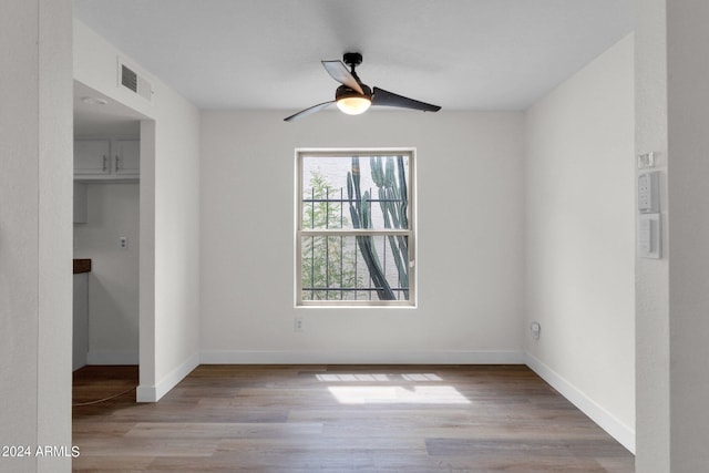 spare room with ceiling fan and light hardwood / wood-style flooring