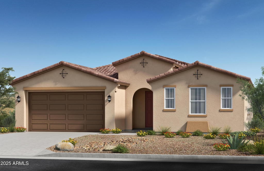 mediterranean / spanish-style house with a garage